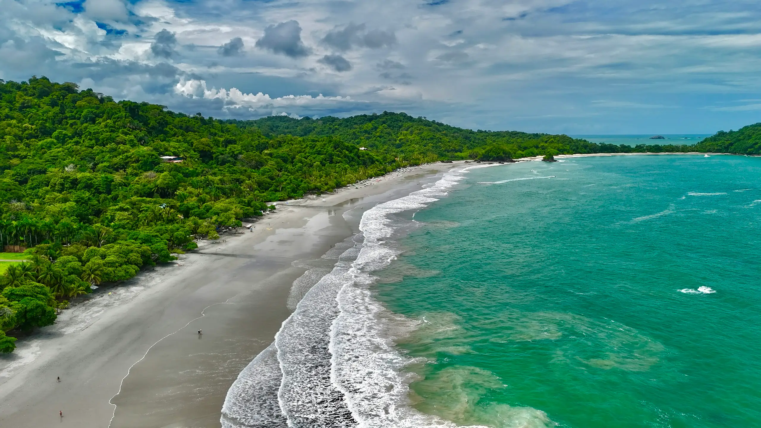 An aerial view of a lush green coastline meeting turquoise surf, Puntarenas, Costa Rica