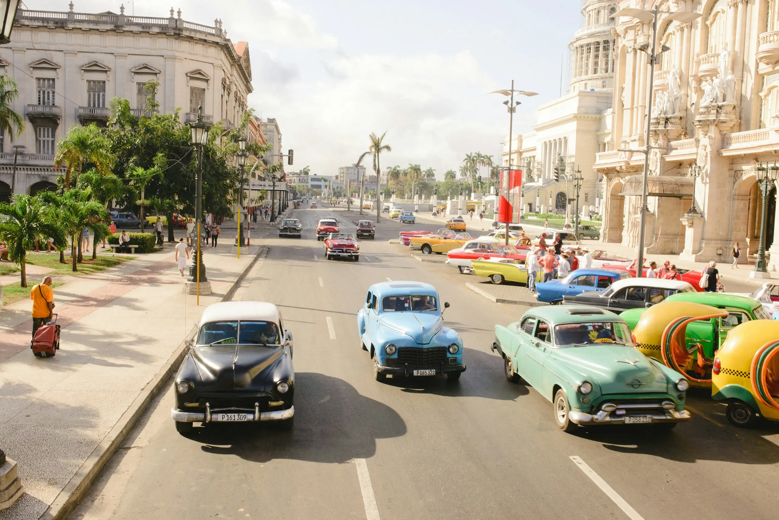 Vintage cars on a street below the domed Capitolio building, Havana, Cuba