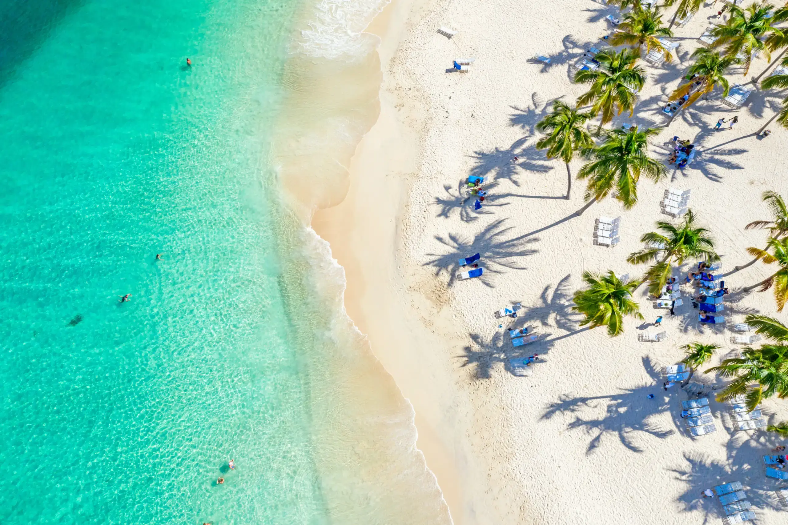Gentle waves on a pale sandy beach at sunset, Dominican Republic
