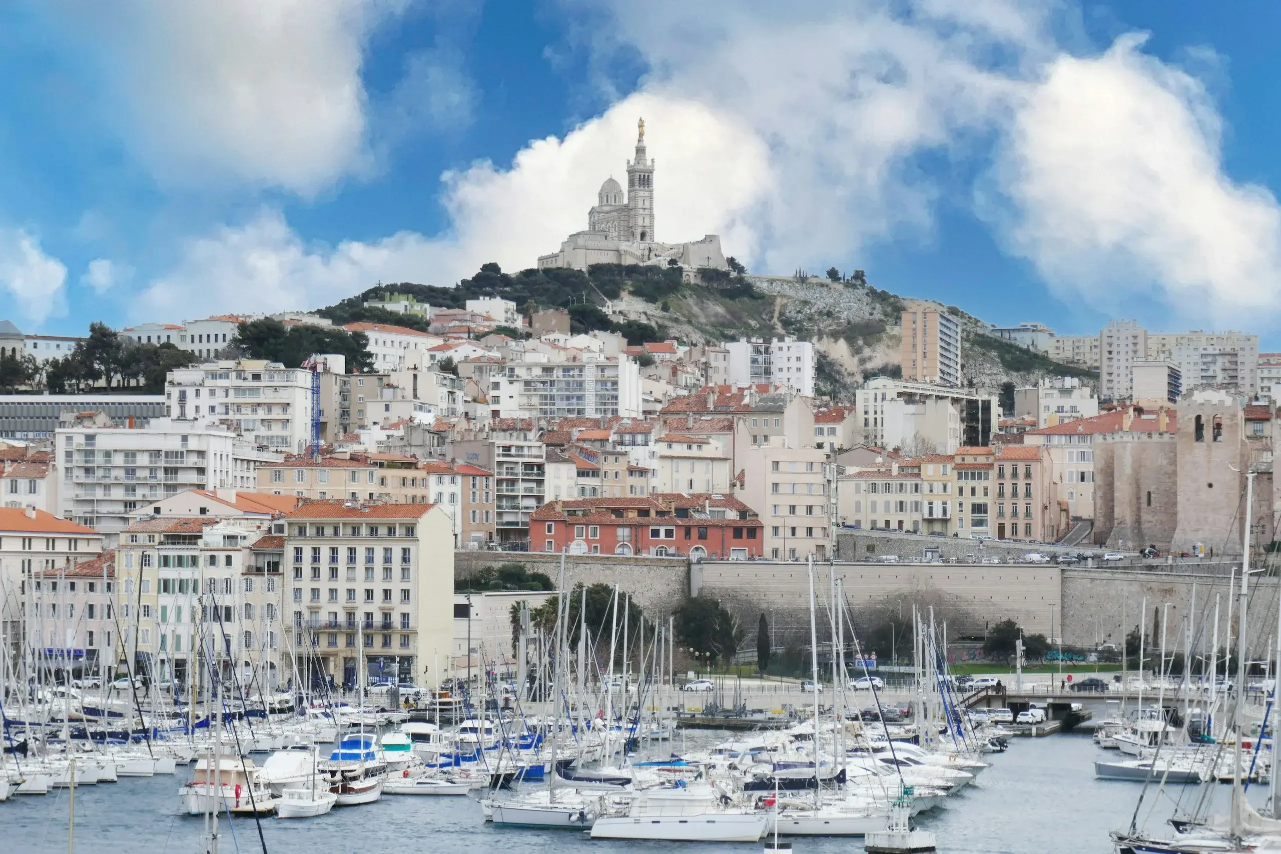Sailboats in the Old Port of Marseille below Notre-Dame de la Garde