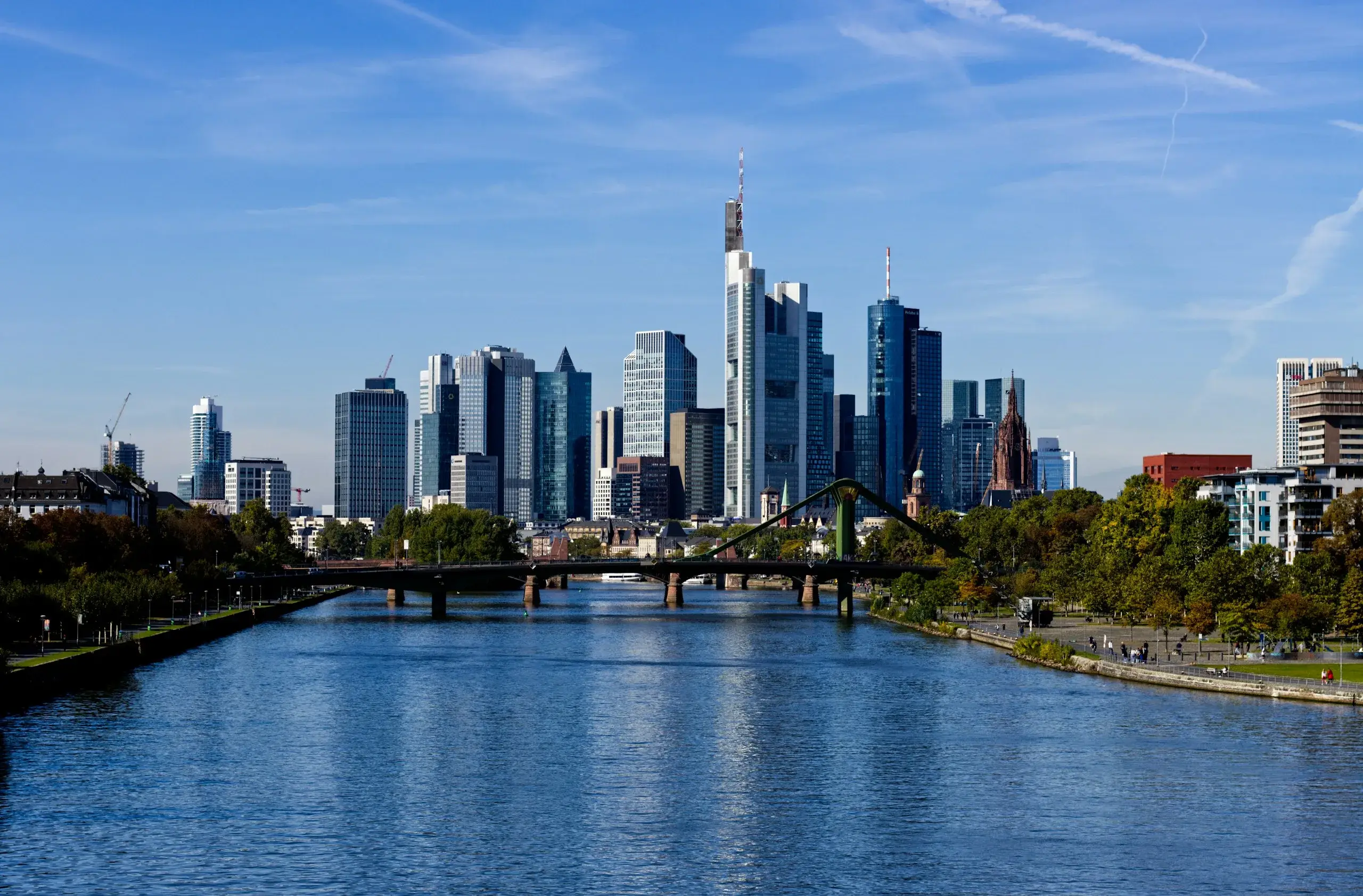 The Frankfurt skyline and a bridge over the Main river on a clear day