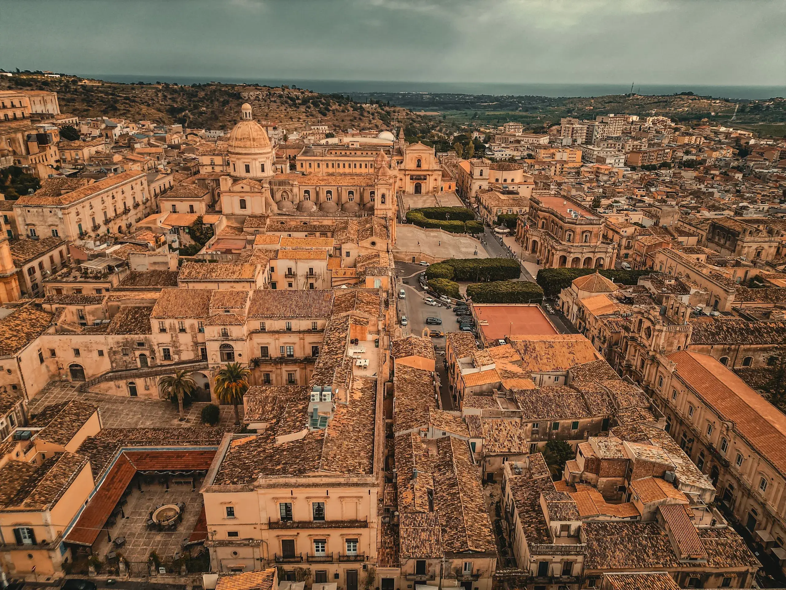 Aerial view of Noto's baroque rooftops and domes in golden light