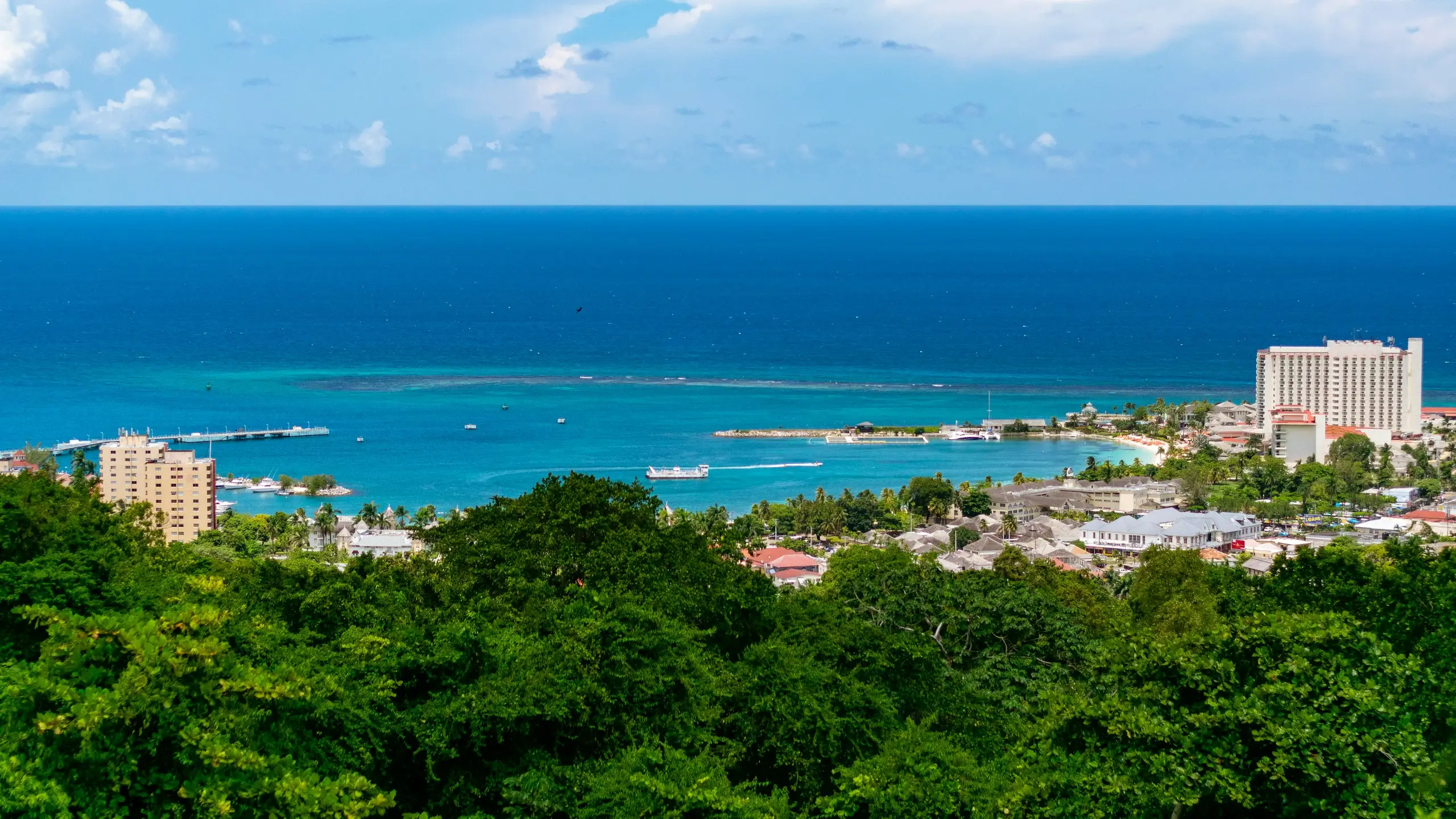 An aerial view of Ocho Rios and its turquoise bay backed by green hills, Jamaica