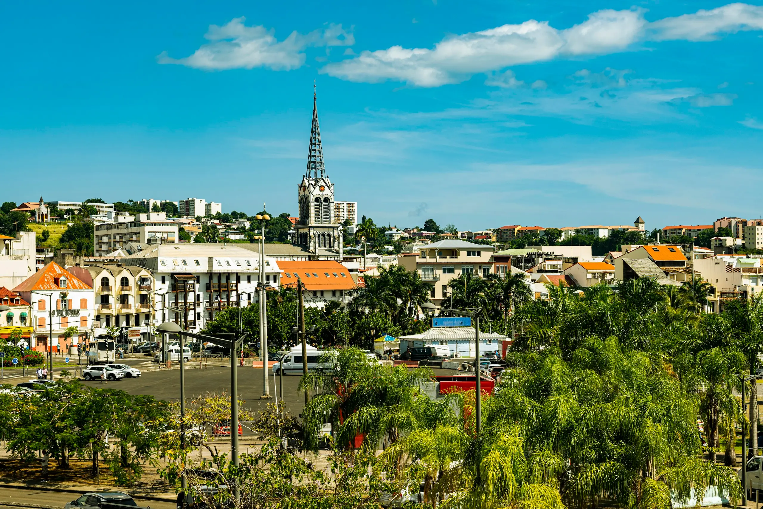 The cathedral spire rising over the rooftops and palms of Fort-de-France, Martinique