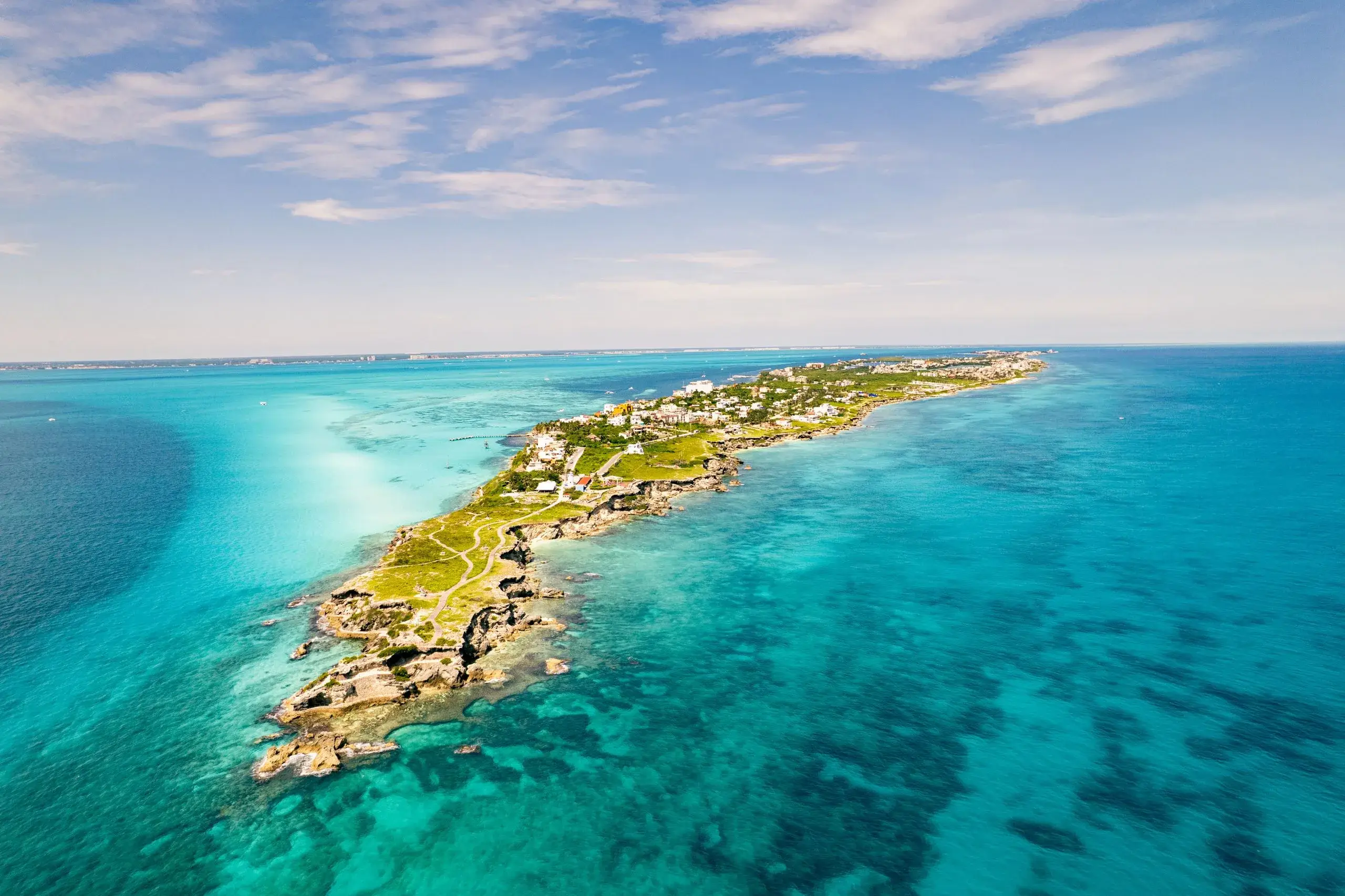 Aerial view of Isla Mujeres stretched across turquoise Caribbean water