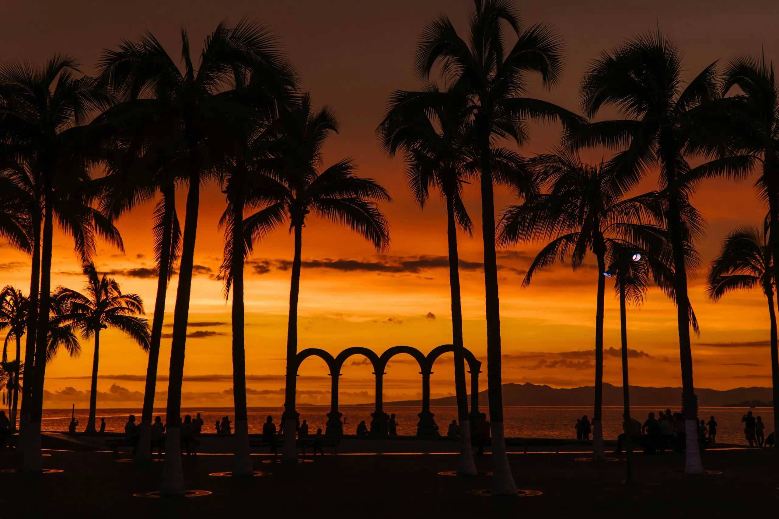 The Los Arcos arches on the Malecon silhouetted against a fiery sunset, Puerto Vallarta, Mexico
