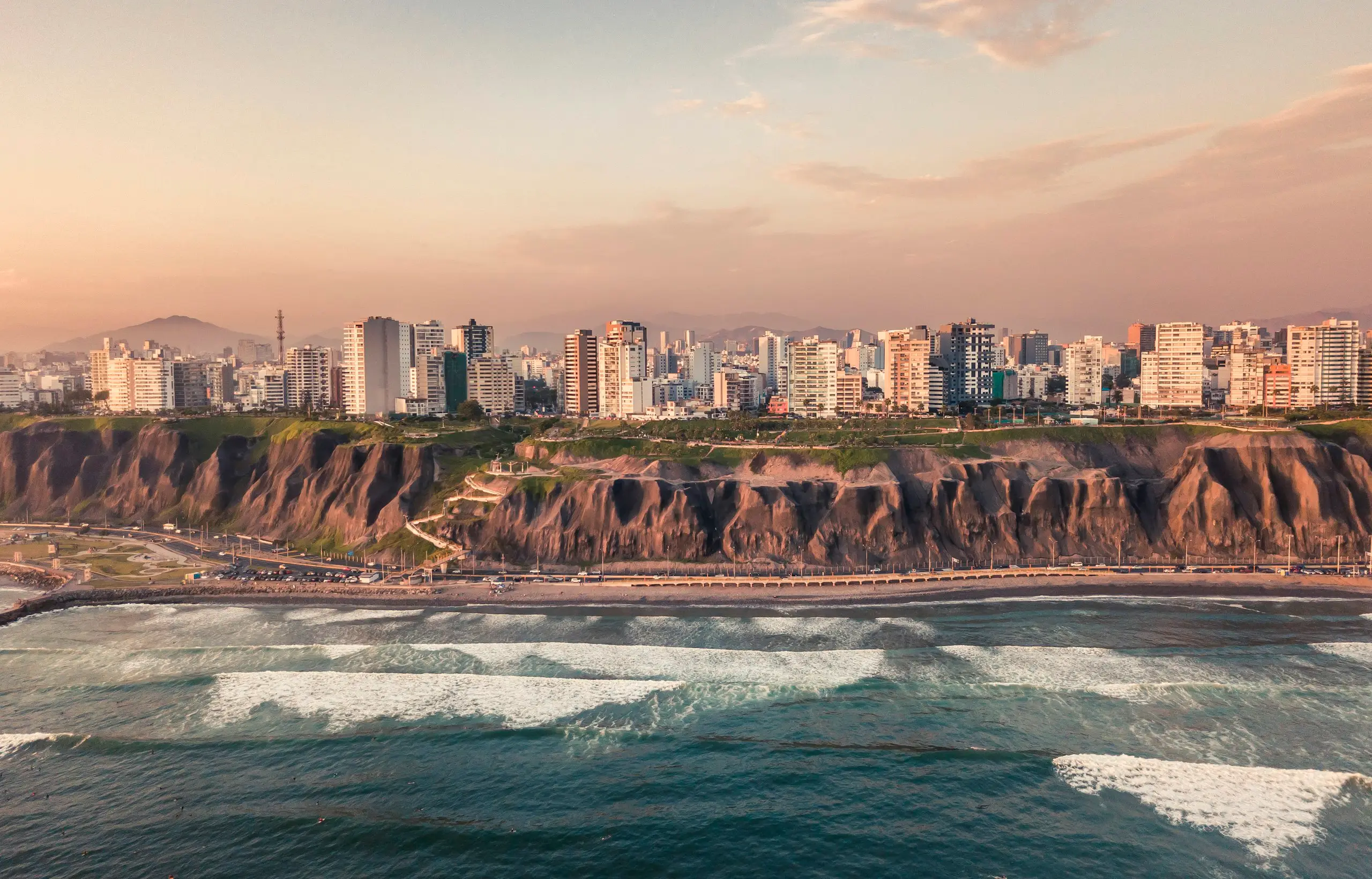 Cliffs and surf along the coast of Lima, Peru