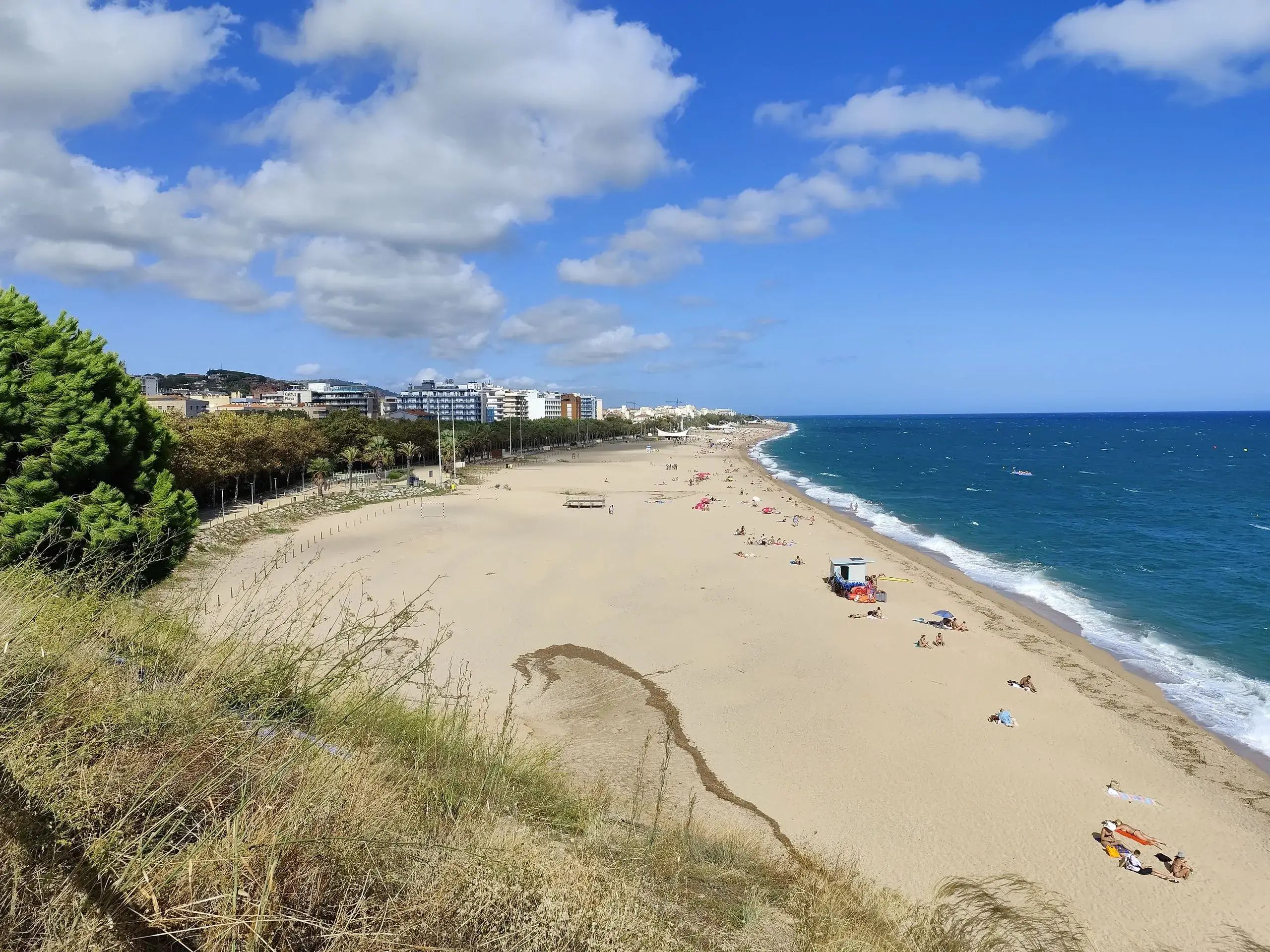 Long sandy beach along the blue Mediterranean at Calella