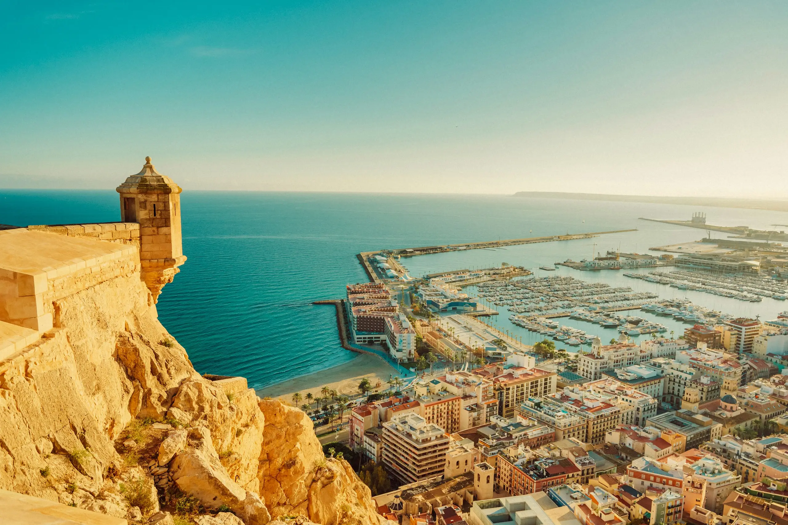 A hilltop castle overlooking a marina and coastal city, Alicante, Spain