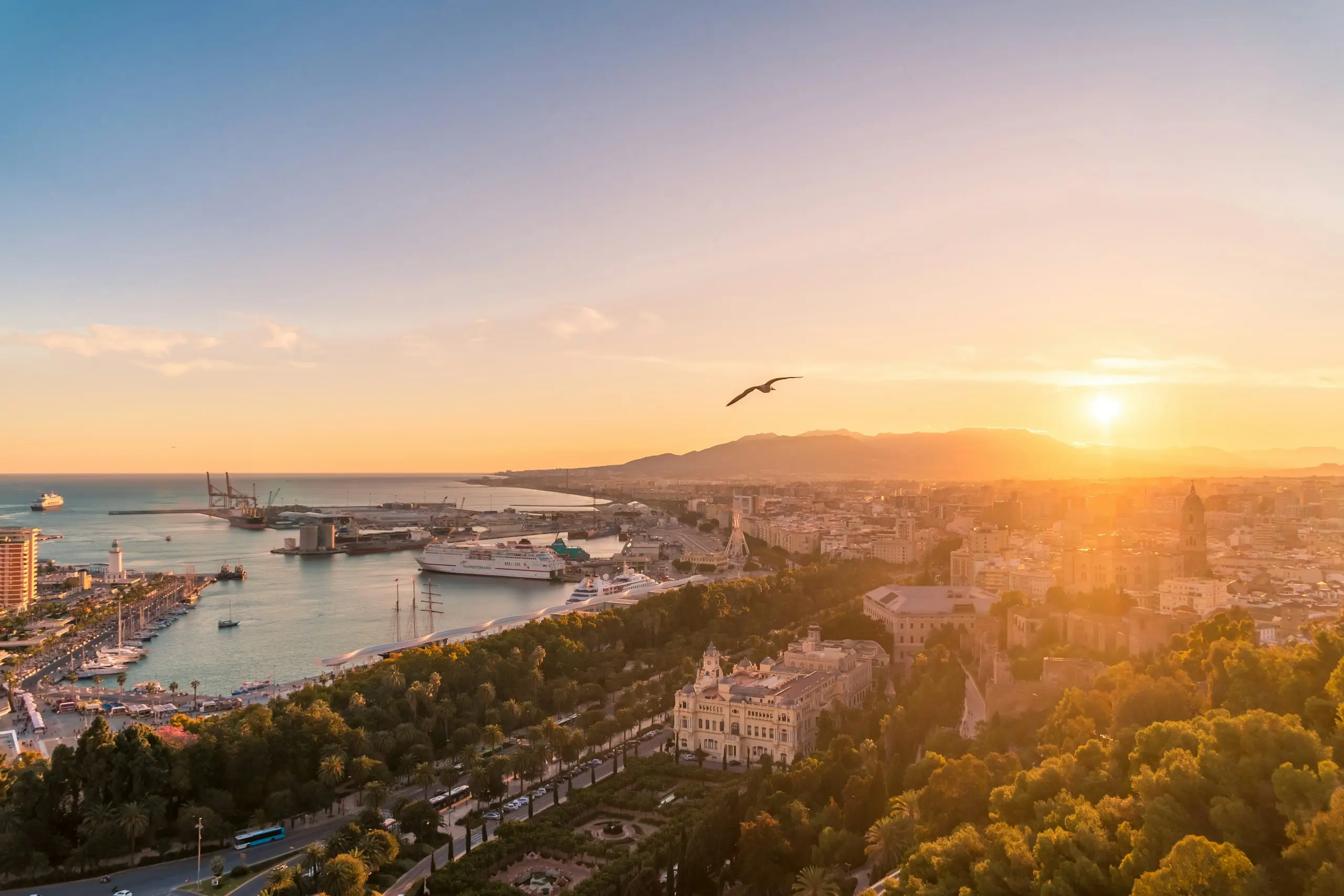 A harbour and coastline at sunset on Spain's Costa del Sol