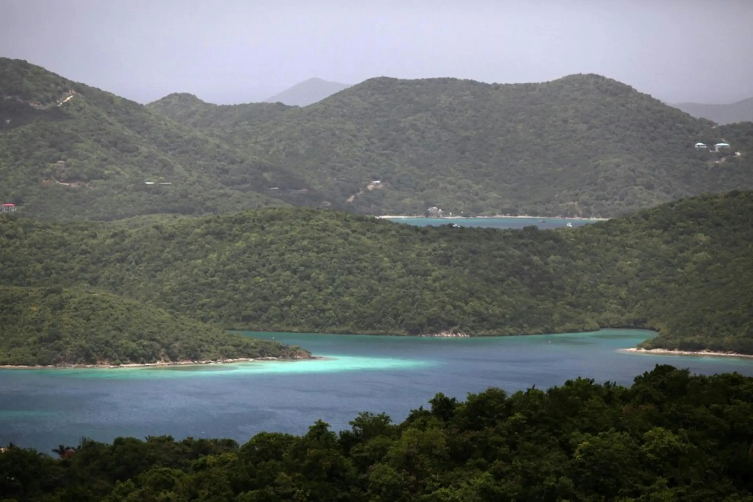 Green hills above turquoise coves and deep bays, Turks and Caicos