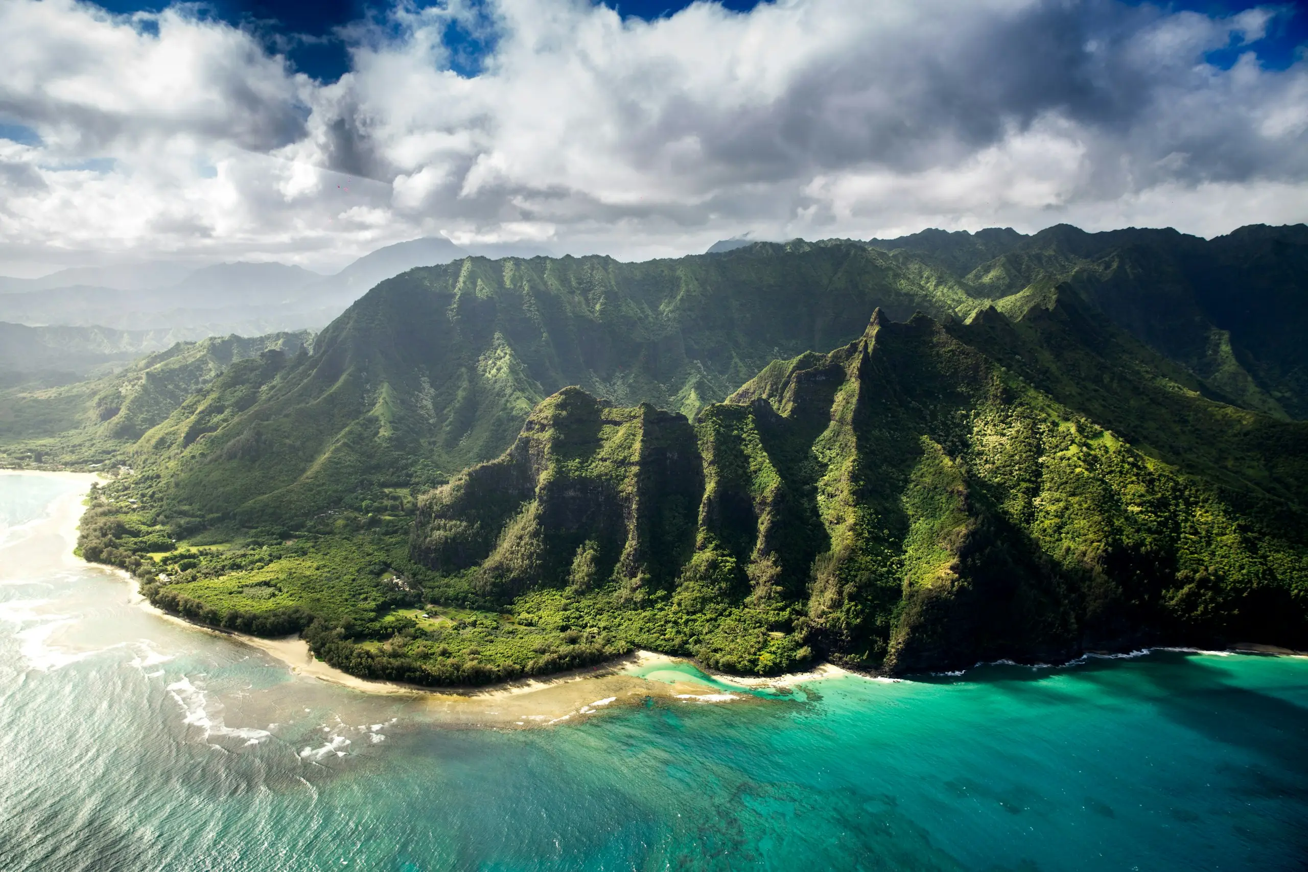Green cliffs and turquoise water along the Kauai coast, near Lihue