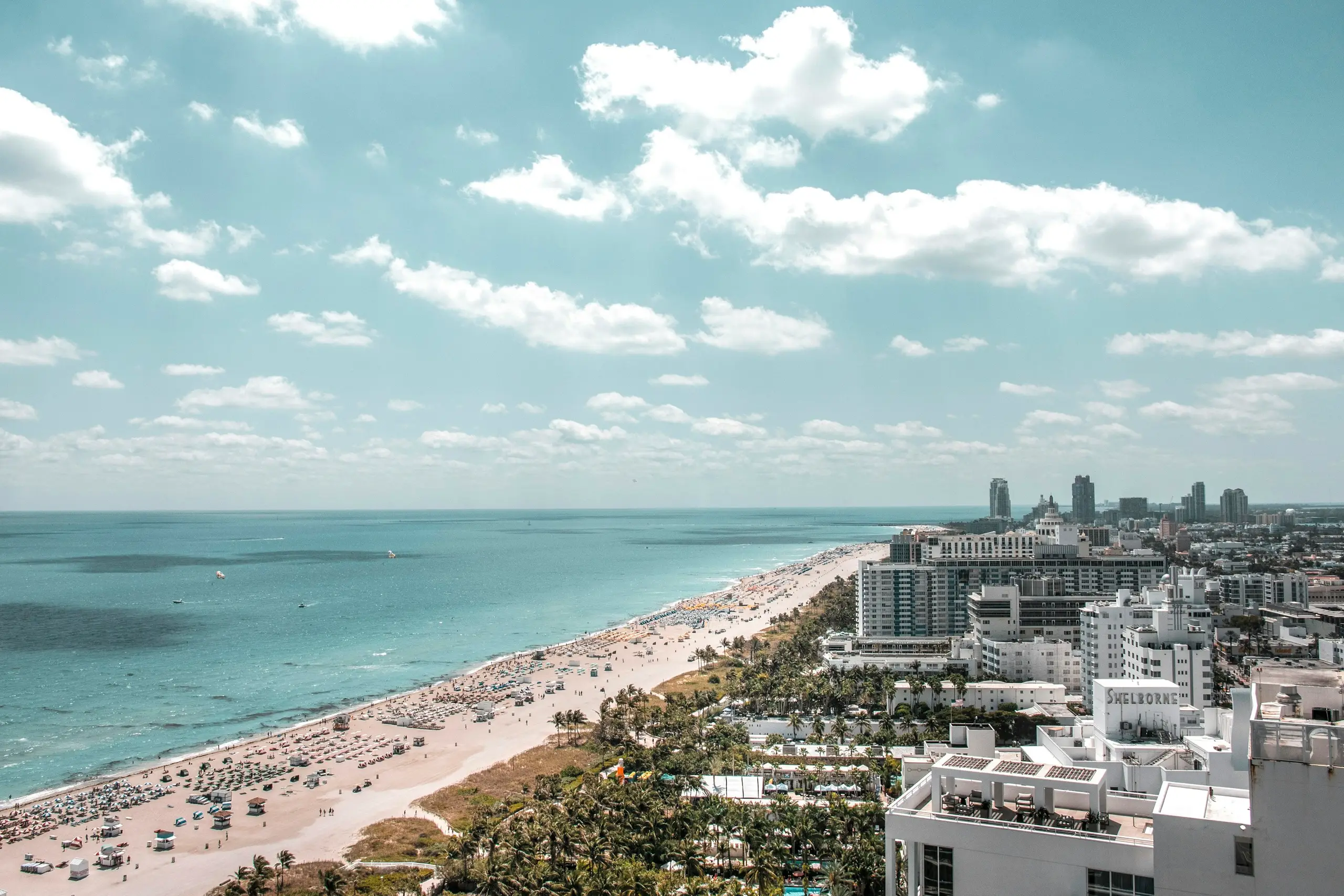 An aerial view of the South Beach coastline and Art Deco hotels along the sand, Miami, Florida