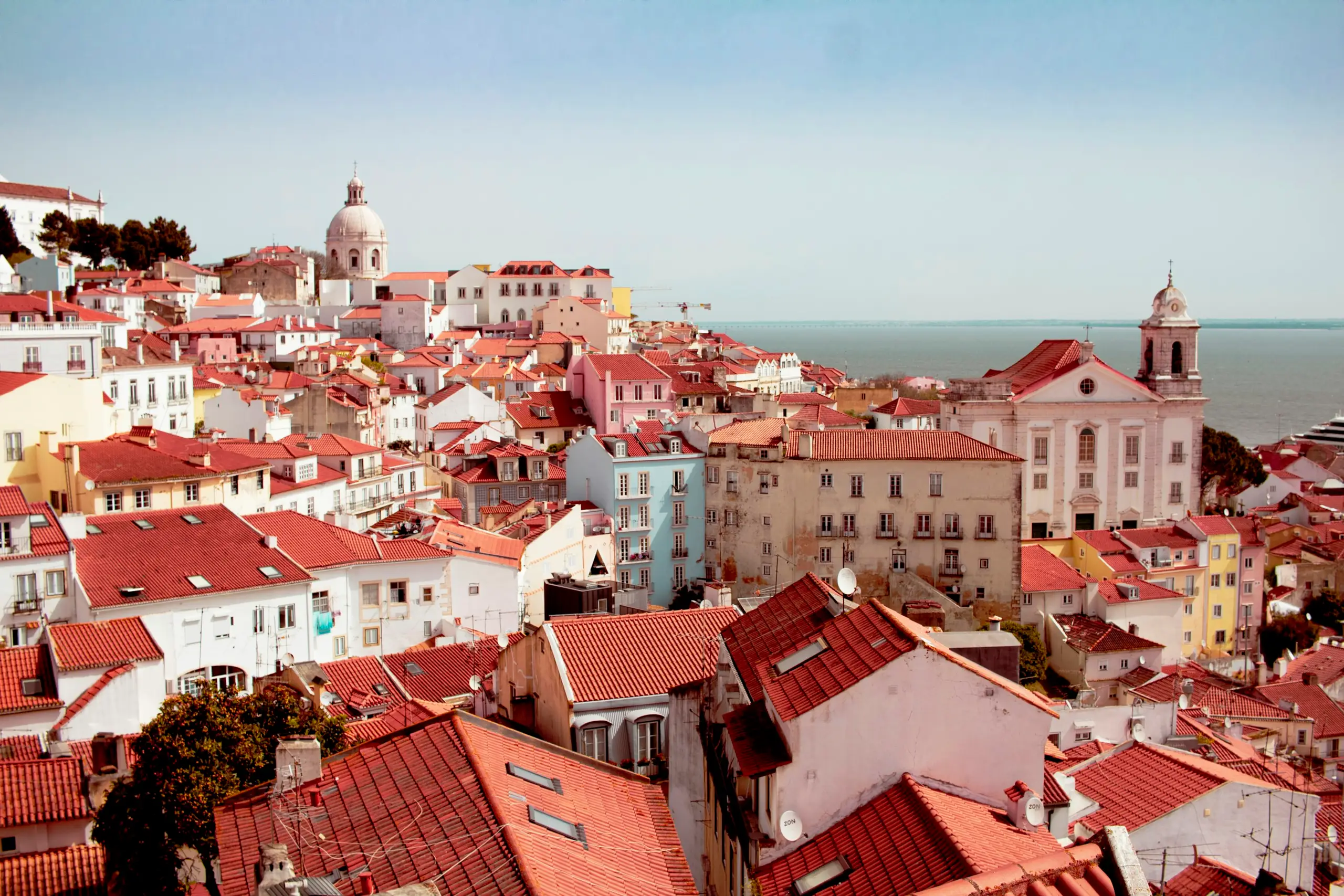 Red-roofed houses of Alfama in Lisbon looking out to the Tagus