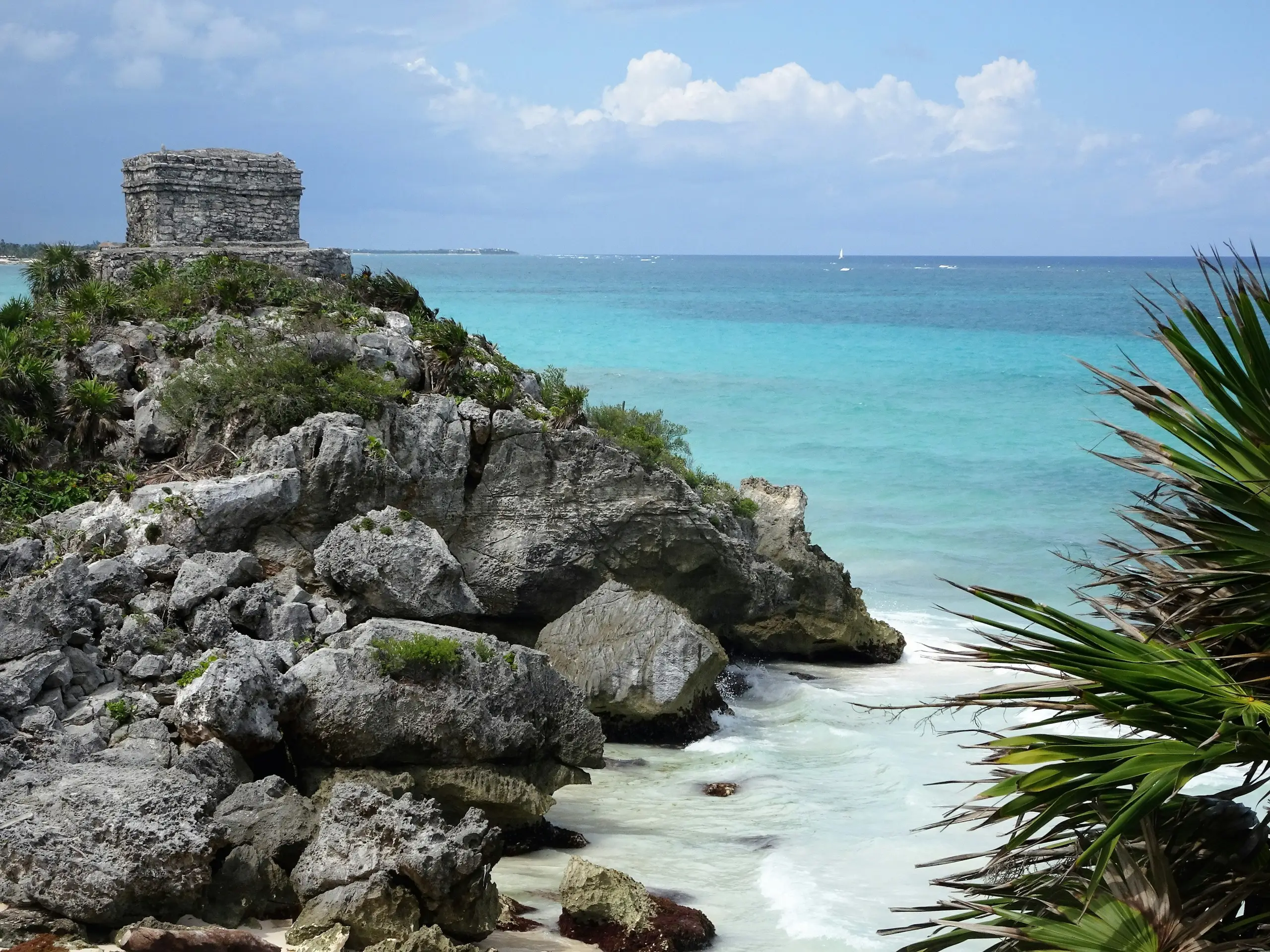 Mayan temple on a rocky cliff above the turquoise Caribbean at Tulum, Mexico